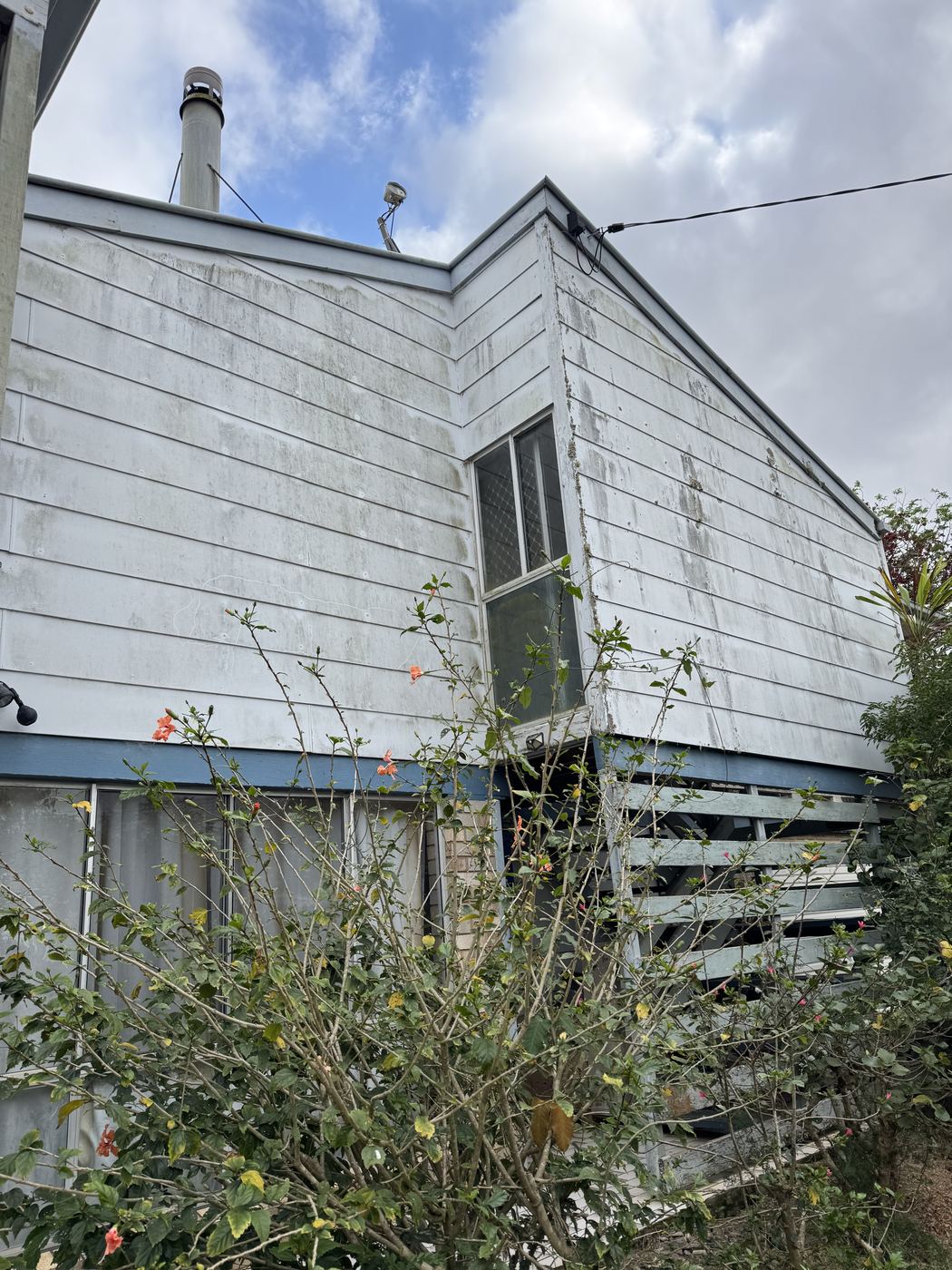 After — Corner weatherboard home clean white after house washing